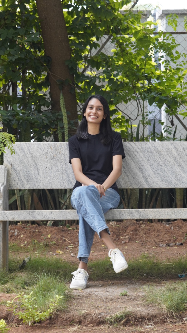Hitha sitting on a bench outdoors